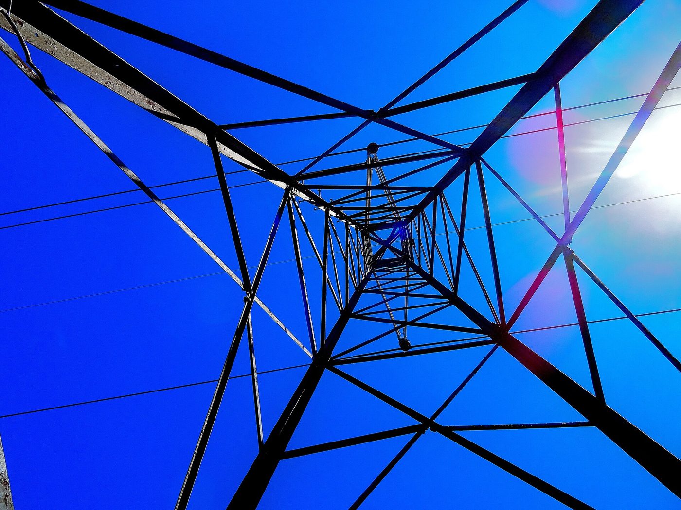 Looking up through a steel lattice transmission pylon