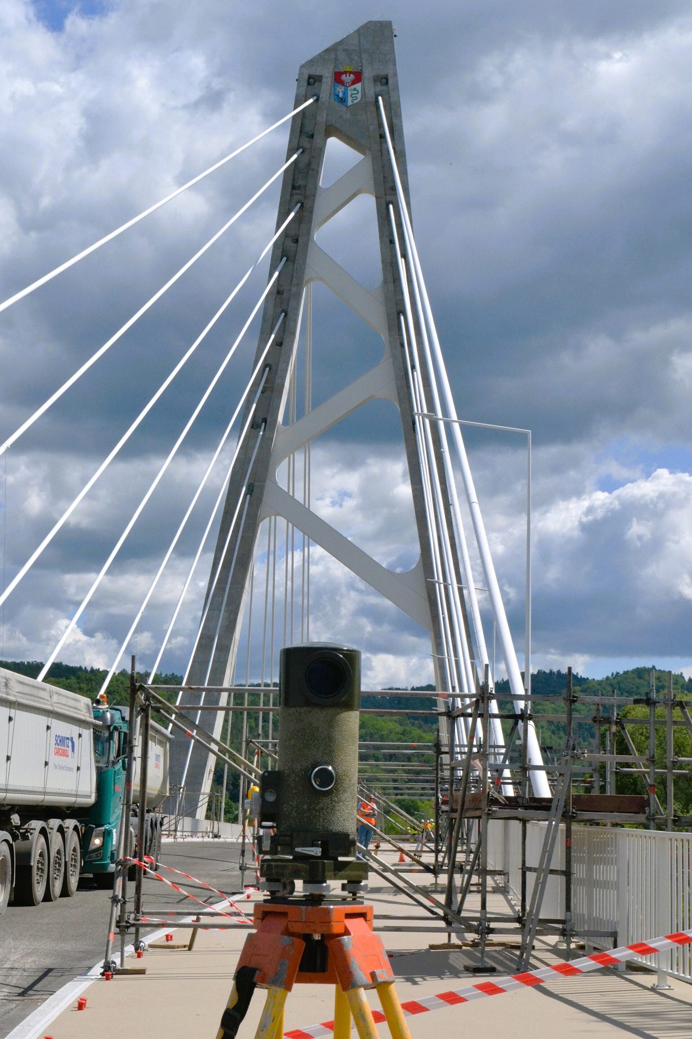 Surveying instrument monitoring a cable-stayed bridge during a proof load test with loaded trucks